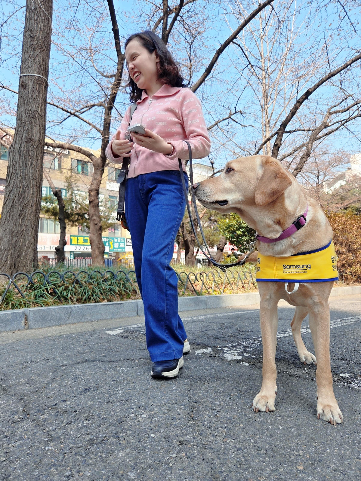 시각장애인 현지수 씨가 안내견&nbsp;‘난초’와 산책을 하고 있다. 박재림 기자
