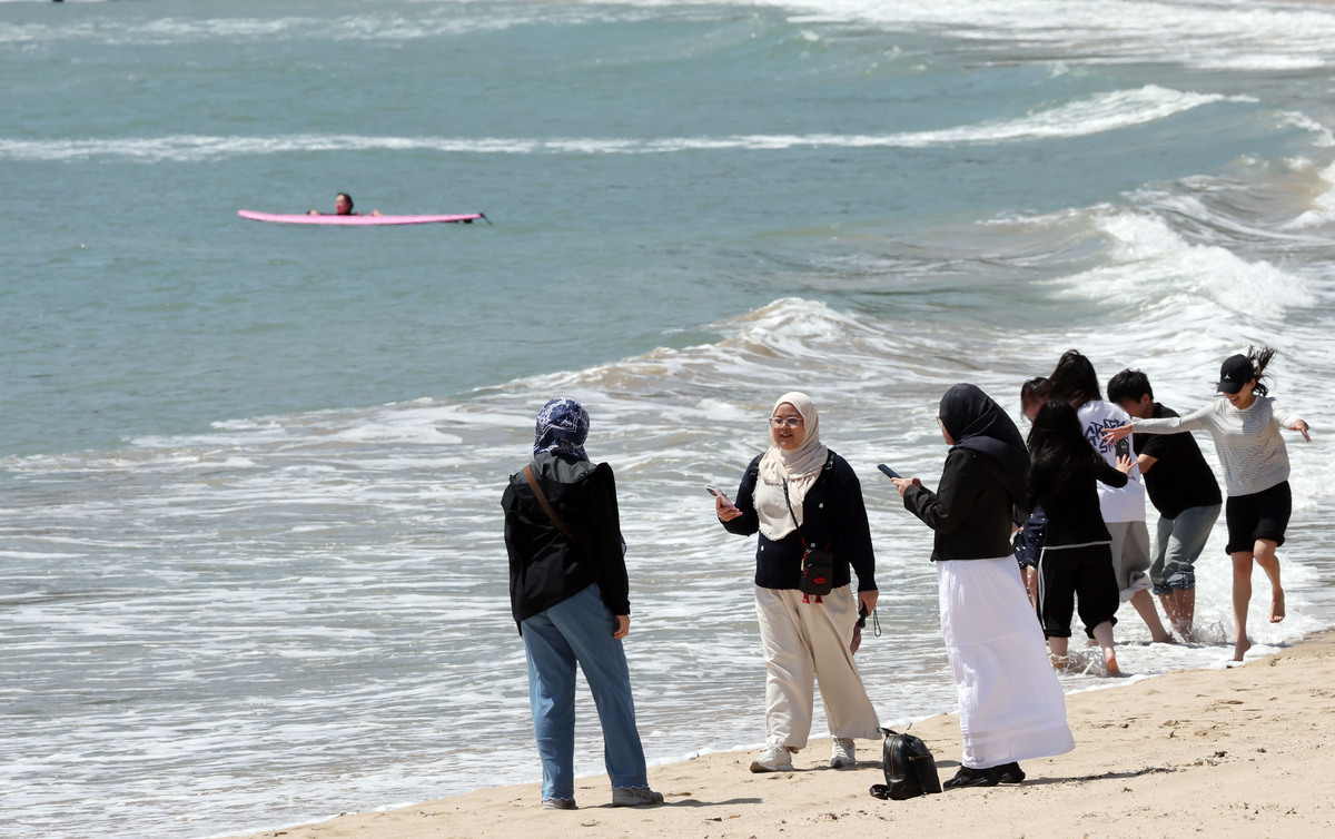외국인 관광객들이 최근 부산 해운대구 송정해수욕장에서 외국인 관광객들이 기념사진을 찍고 있다. 뉴시스